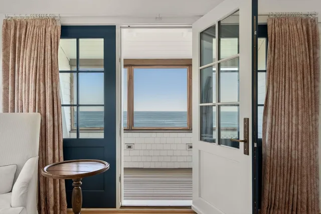 a view of a room with wooden floor and iron stairs