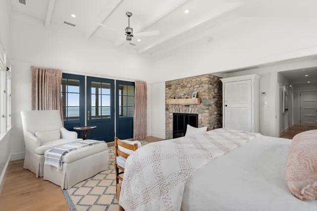 a spacious en suite bathroom with a double vanity sink a mirror a bathtub and window