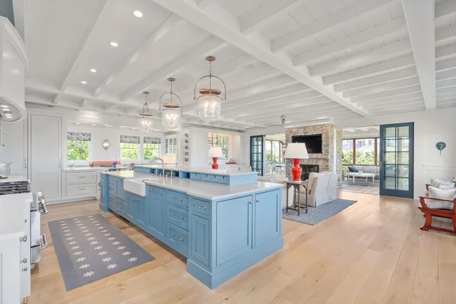 a kitchen view with stainless steel appliances lots of counter space and a window
