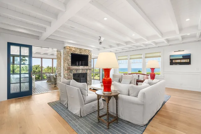 a living room with fireplace furniture and a flat screen tv