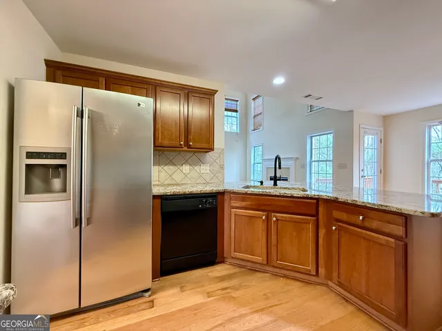 a kitchen with stainless steel appliances granite countertop a stove a sink and a microwave