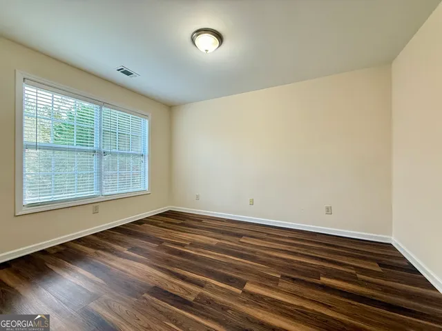 a bathroom with a toilet a sink and a mirror