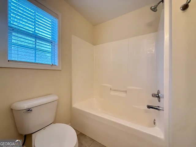 a balcony with wooden floor and trees