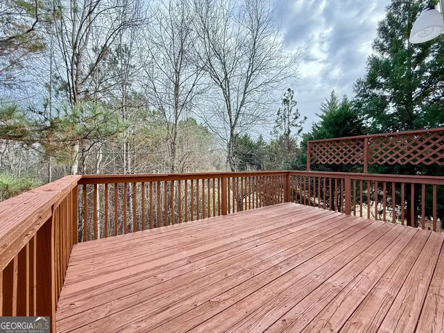 a view of a deck with wooden floor and fence