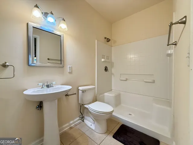 a bathroom with a toilet and a shower