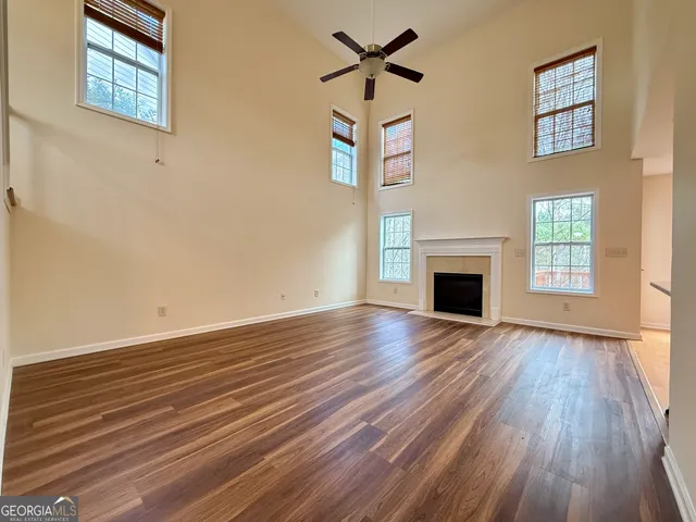 a view of empty room with wooden floor and fireplace
