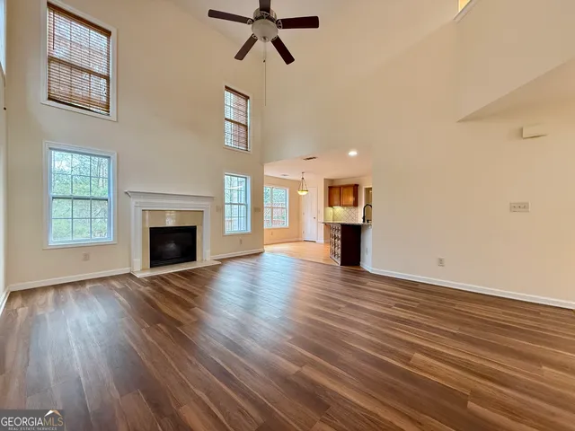 a view of empty room with a fireplace and wooden floor