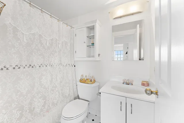 a white toilet sitting next to a bathroom sink