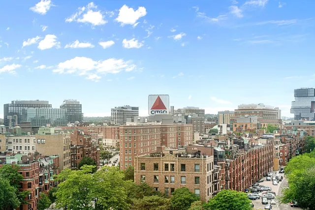 a view of a city with tall buildings and a big yard