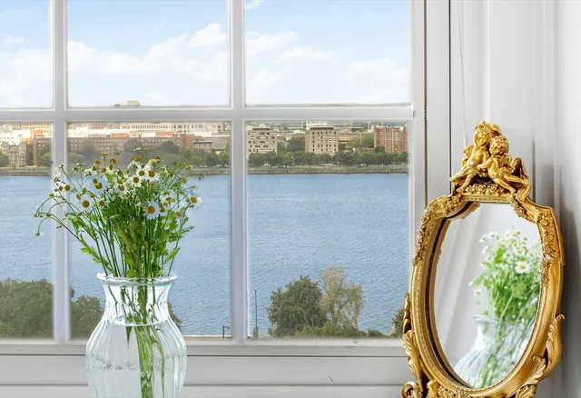 a view of a vase of flowers sitting on a table with window