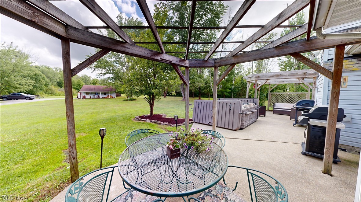 7115 Brakeman Road Painesville, OH 44077 - Photo 43 of 47 View of patio / terrace featuring a pergola, an outdoor fire pit, and a hot tub