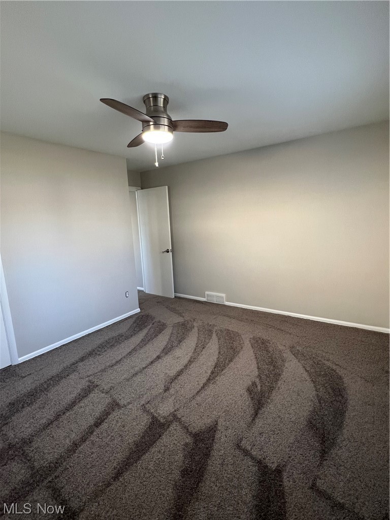 19306 Libby Road Maple Heights, OH 44137 - Photo 19 of 33 Carpeted empty room with ceiling fan