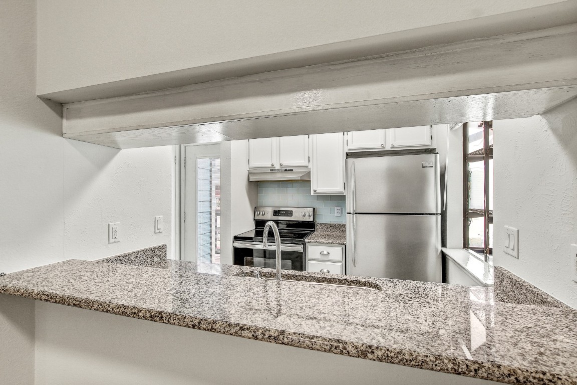 2215 Post Road, Unit 2022 Austin, TX 78704 - Photo 7 of 15 a kitchen with a refrigerator and a sink