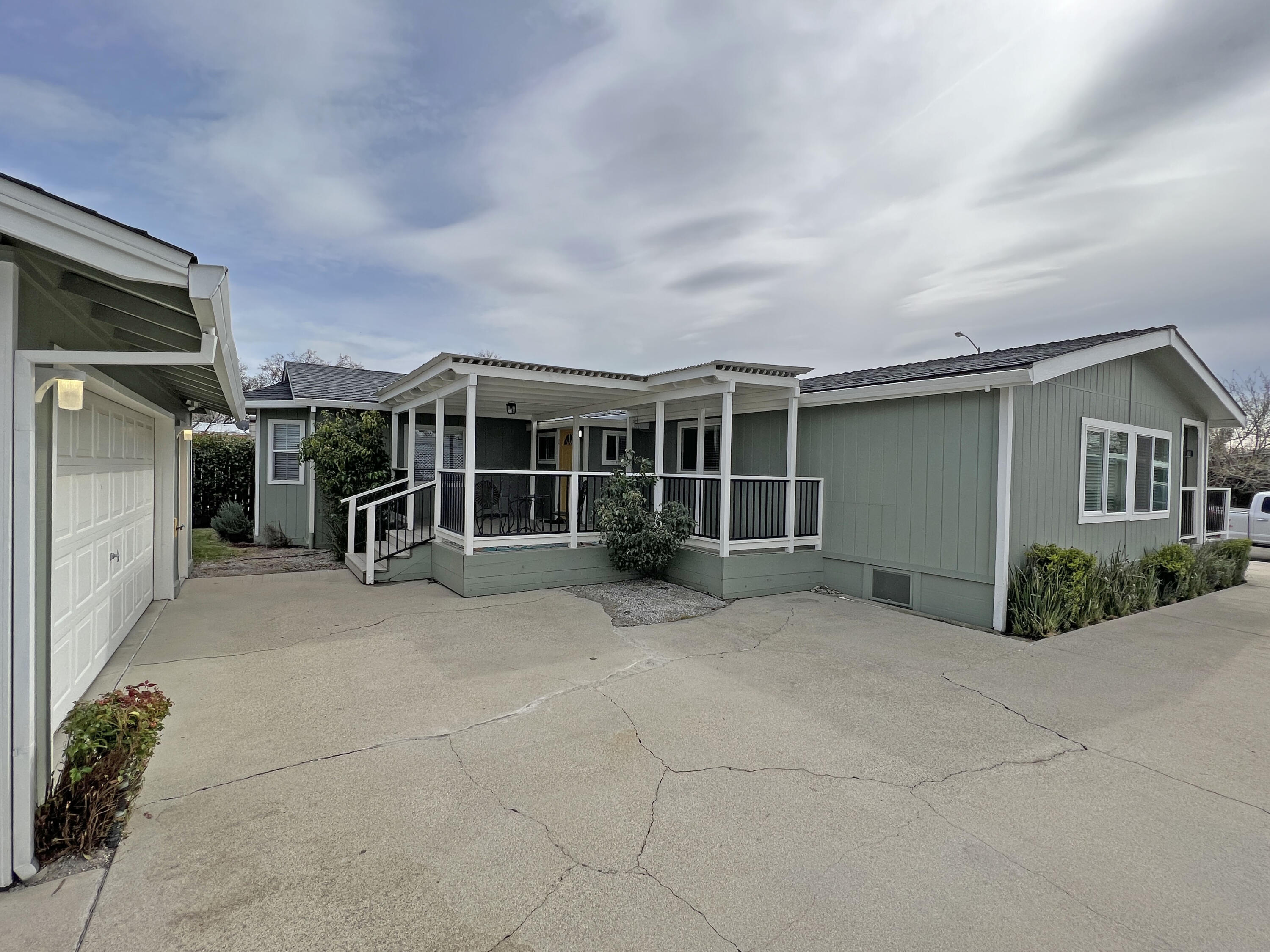 1183 Fox Den Drive Redding, CA 96003 - Photo 15 of 17 a view of a house with a floor to ceiling window and potted plants
