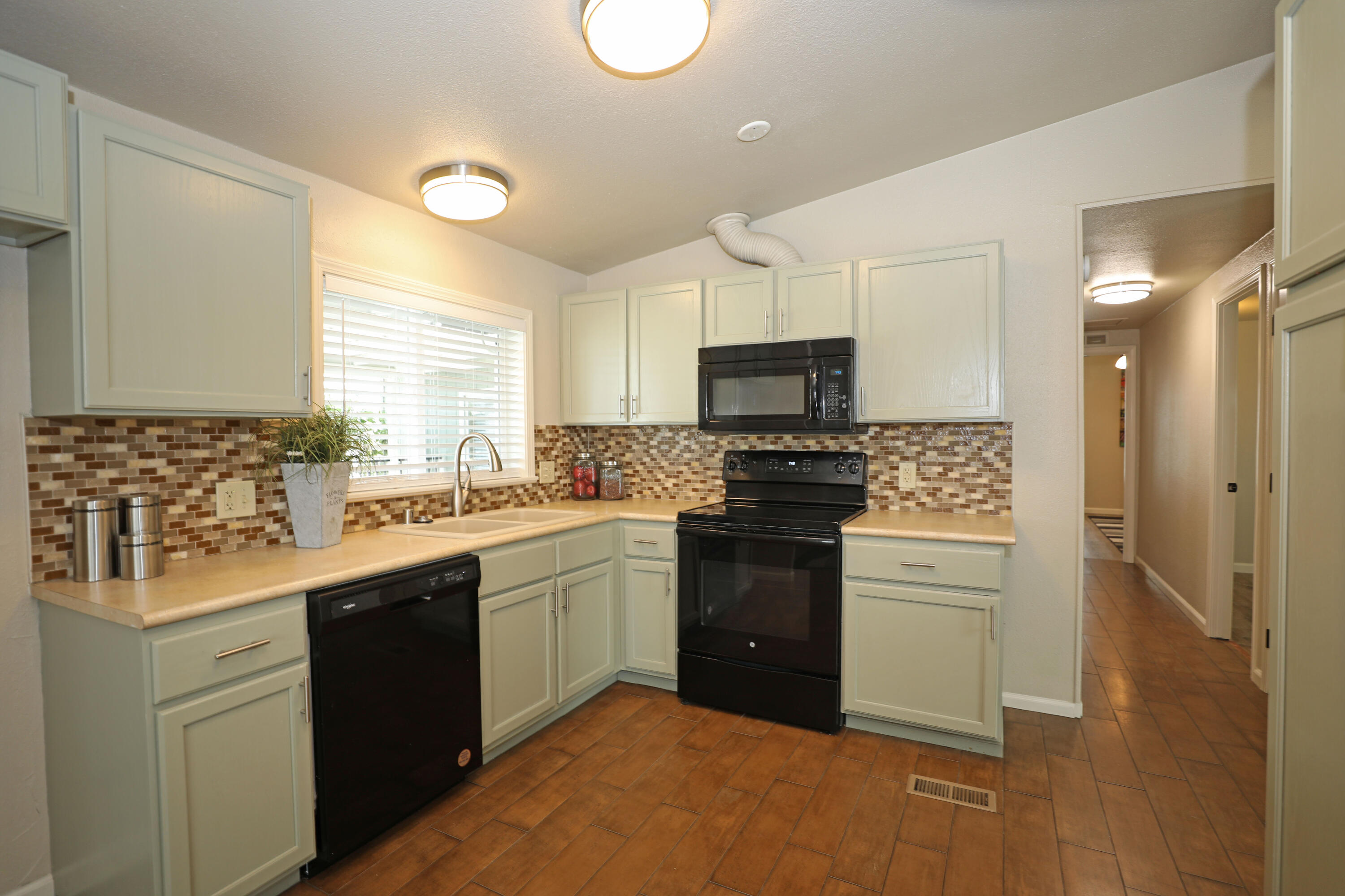 1183 Fox Den Drive Redding, CA 96003 - Photo 3 of 17 a kitchen with a sink stove and refrigerator