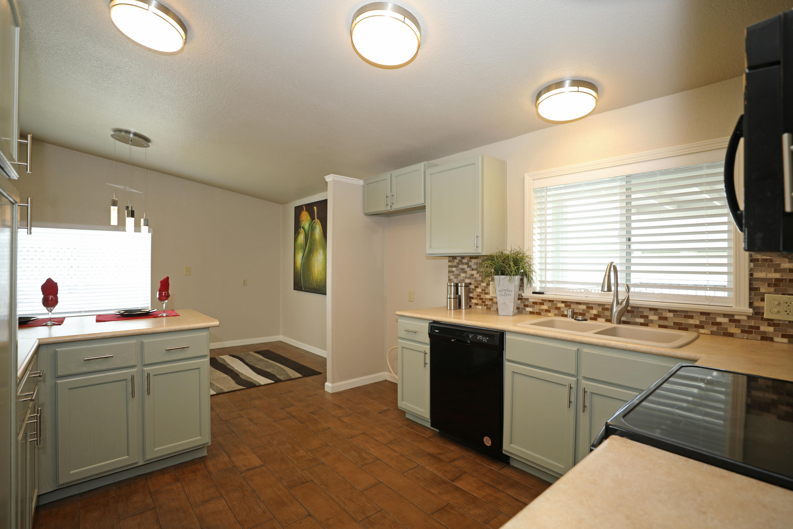 1183 Fox Den Drive Redding, CA 96003 - Photo 4 of 17 a kitchen that has a sink and a stove in it