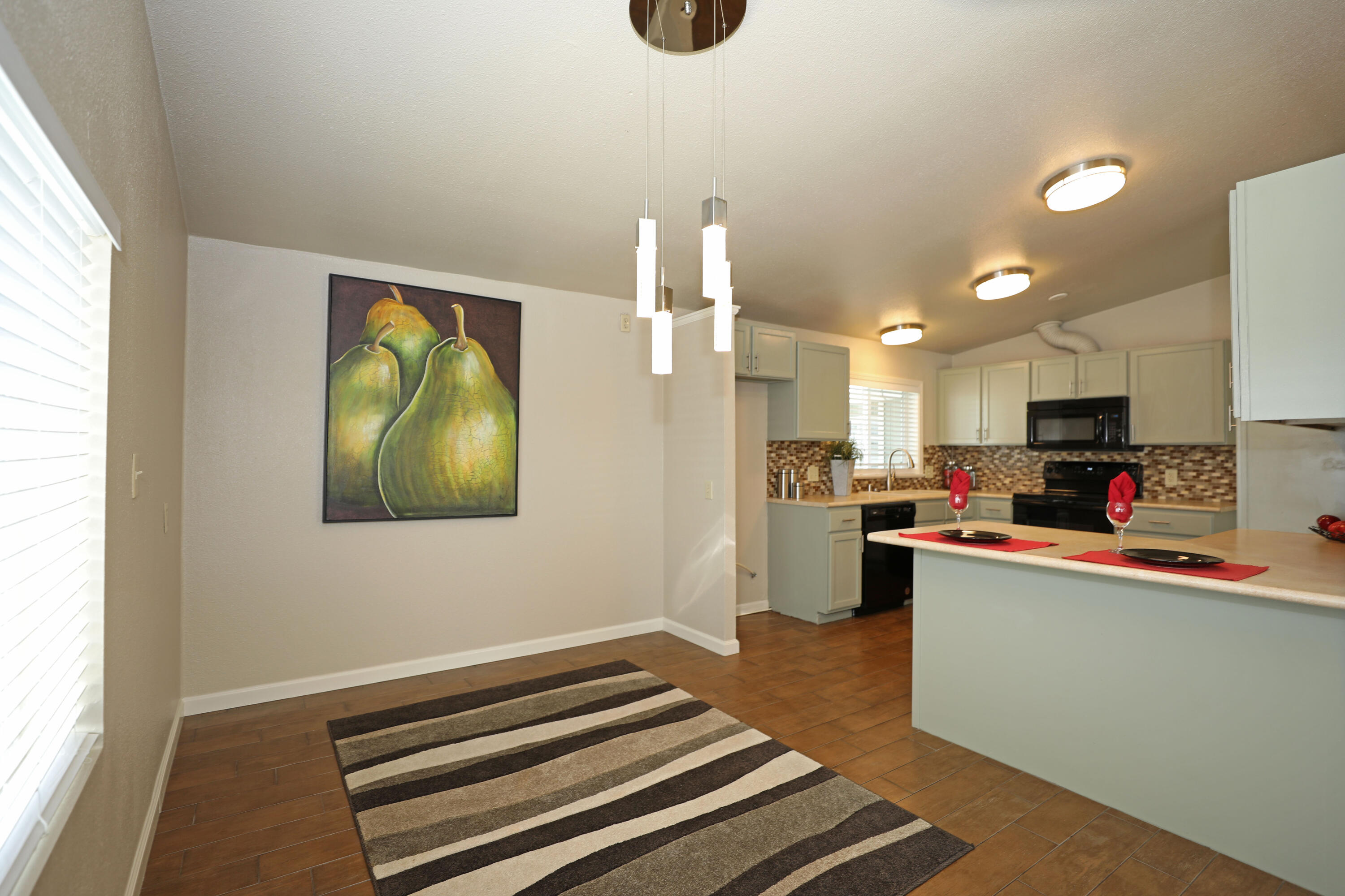 1183 Fox Den Drive Redding, CA 96003 - Photo 5 of 17 a kitchen with stainless steel appliances a refrigerator and a stove top oven
