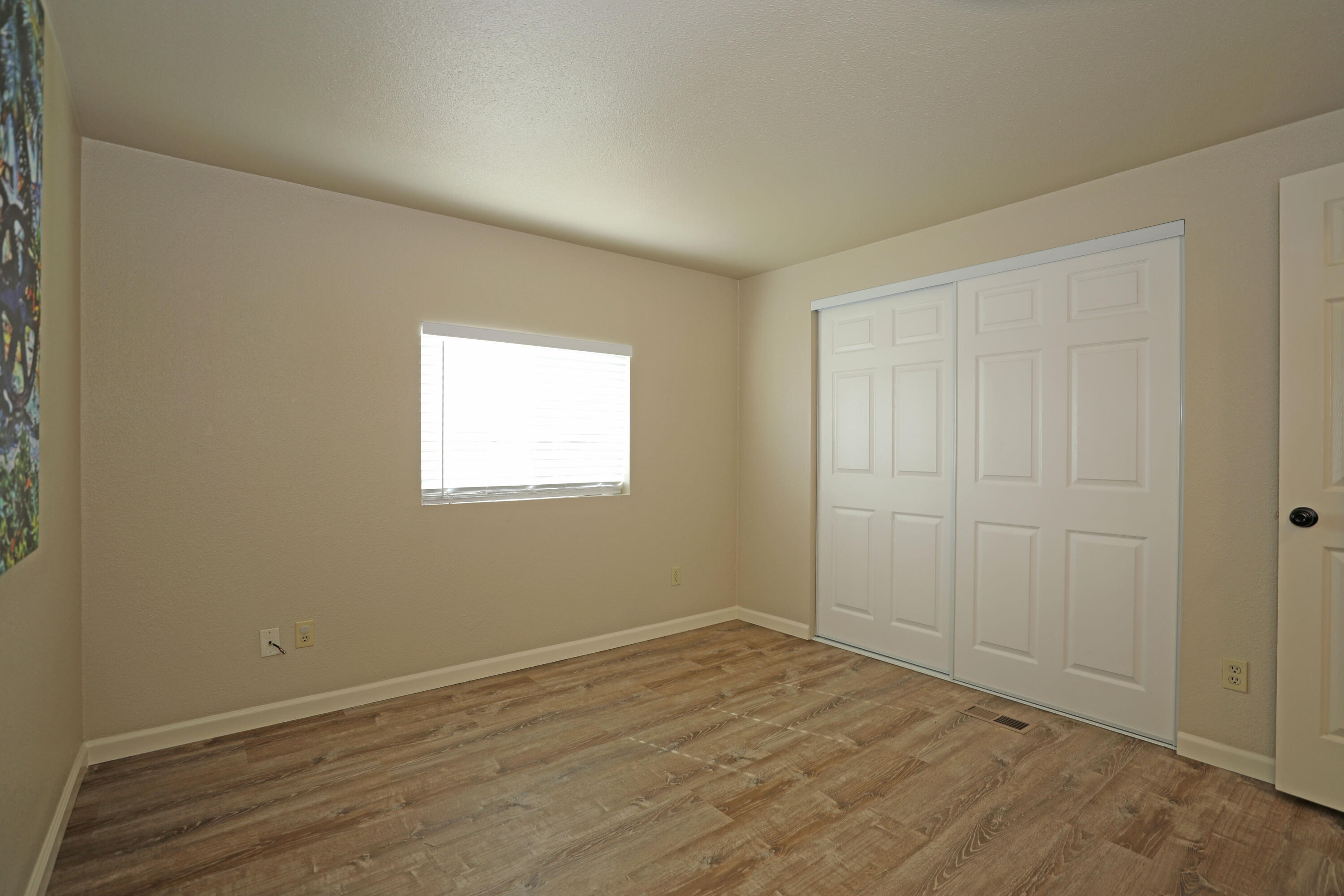 1183 Fox Den Drive Redding, CA 96003 - Photo 6 of 17 an empty room with wooden floor and windows
