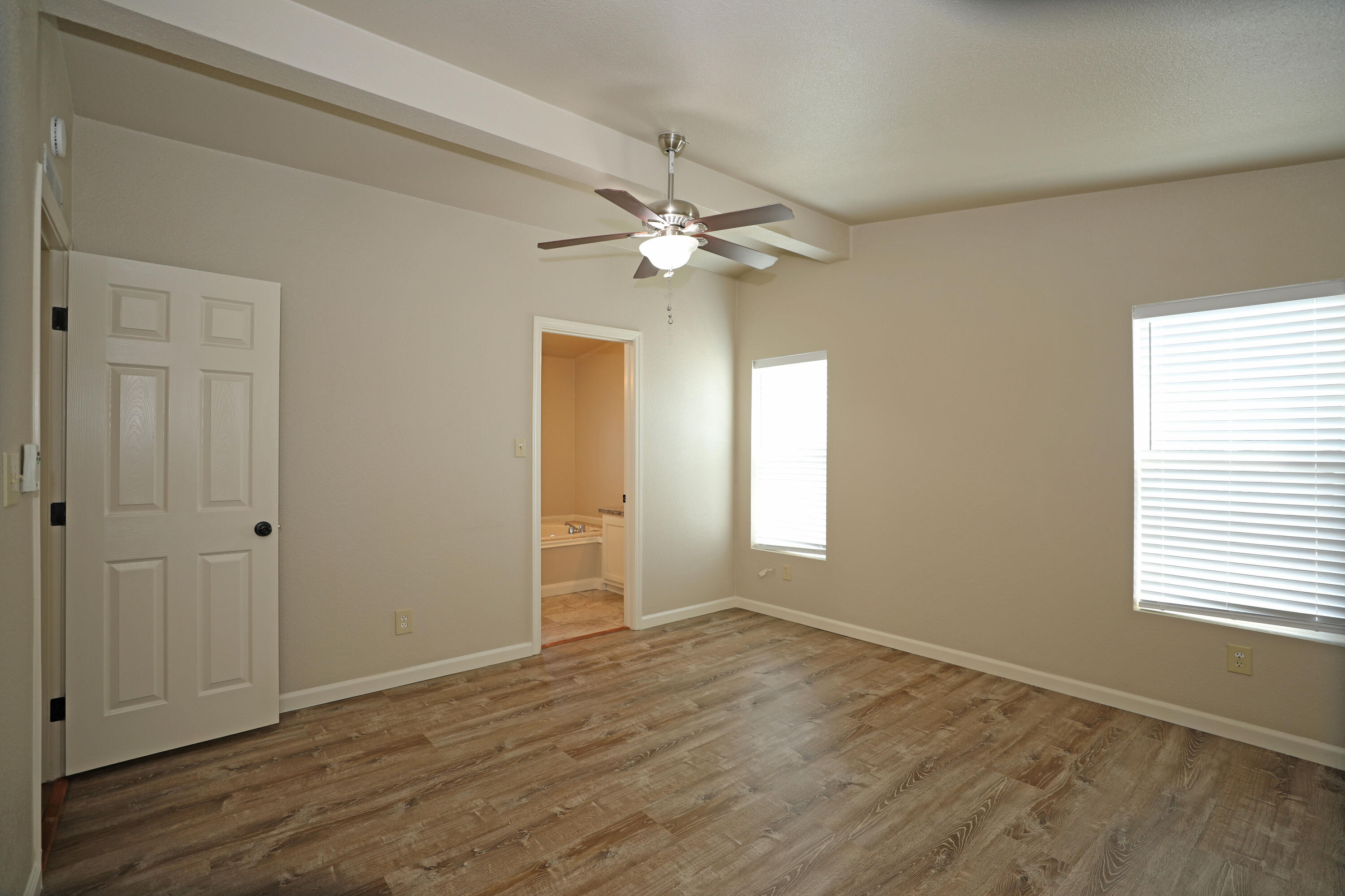 1183 Fox Den Drive Redding, CA 96003 - Photo 9 of 17 a view of an empty room with a window and wooden floor