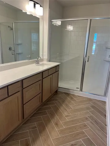 a bathroom with a mirror and a shower