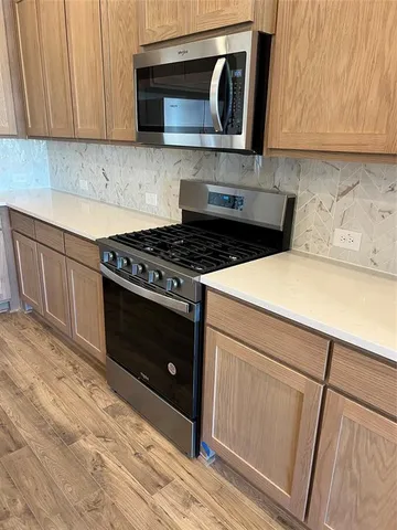 a kitchen with a stove and a microwave