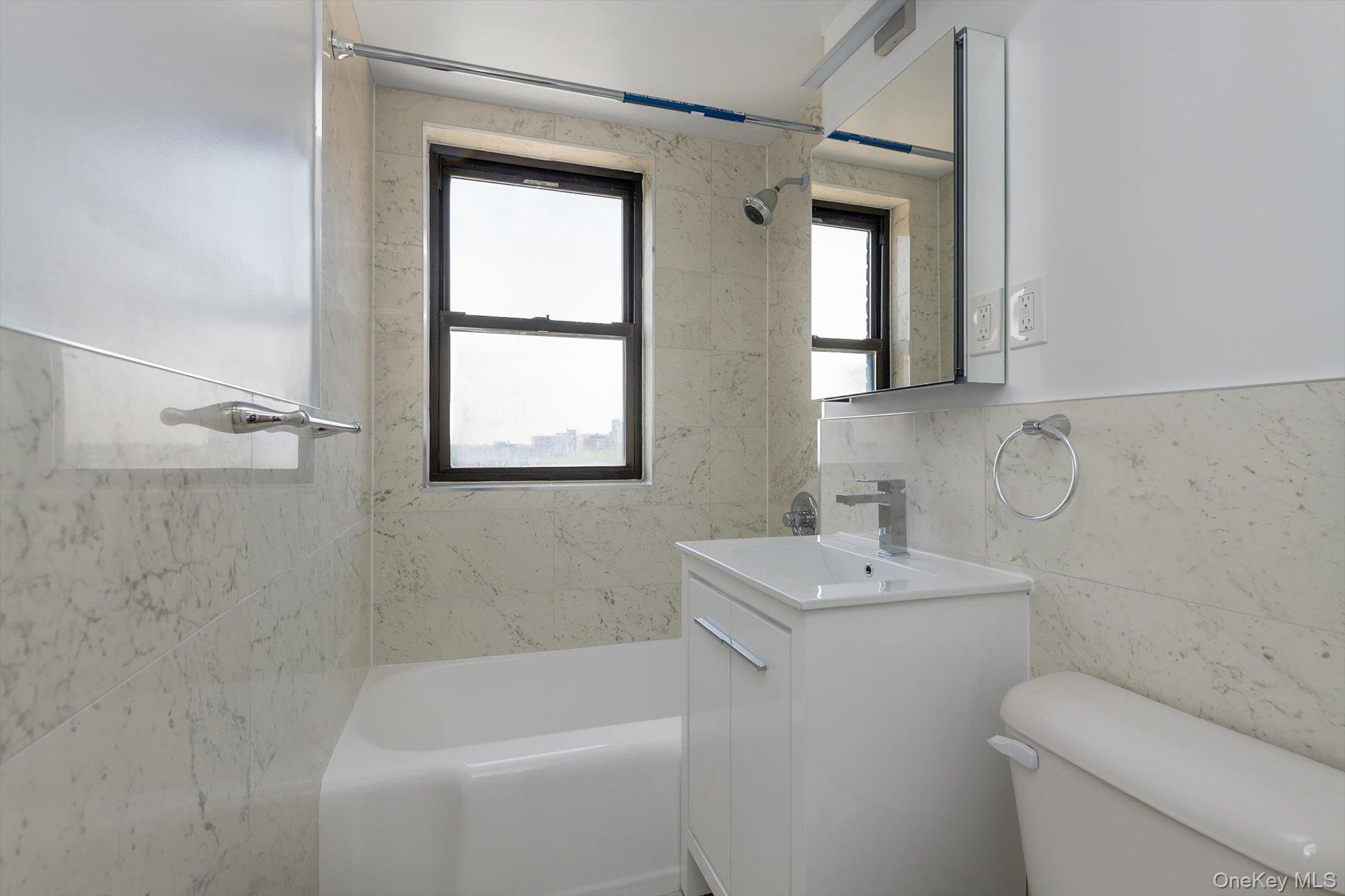 99-52 66th Road, Unit W7 Queens, NY 11374 - Photo 16 of 22 a bathroom with a sink toilet and shower
