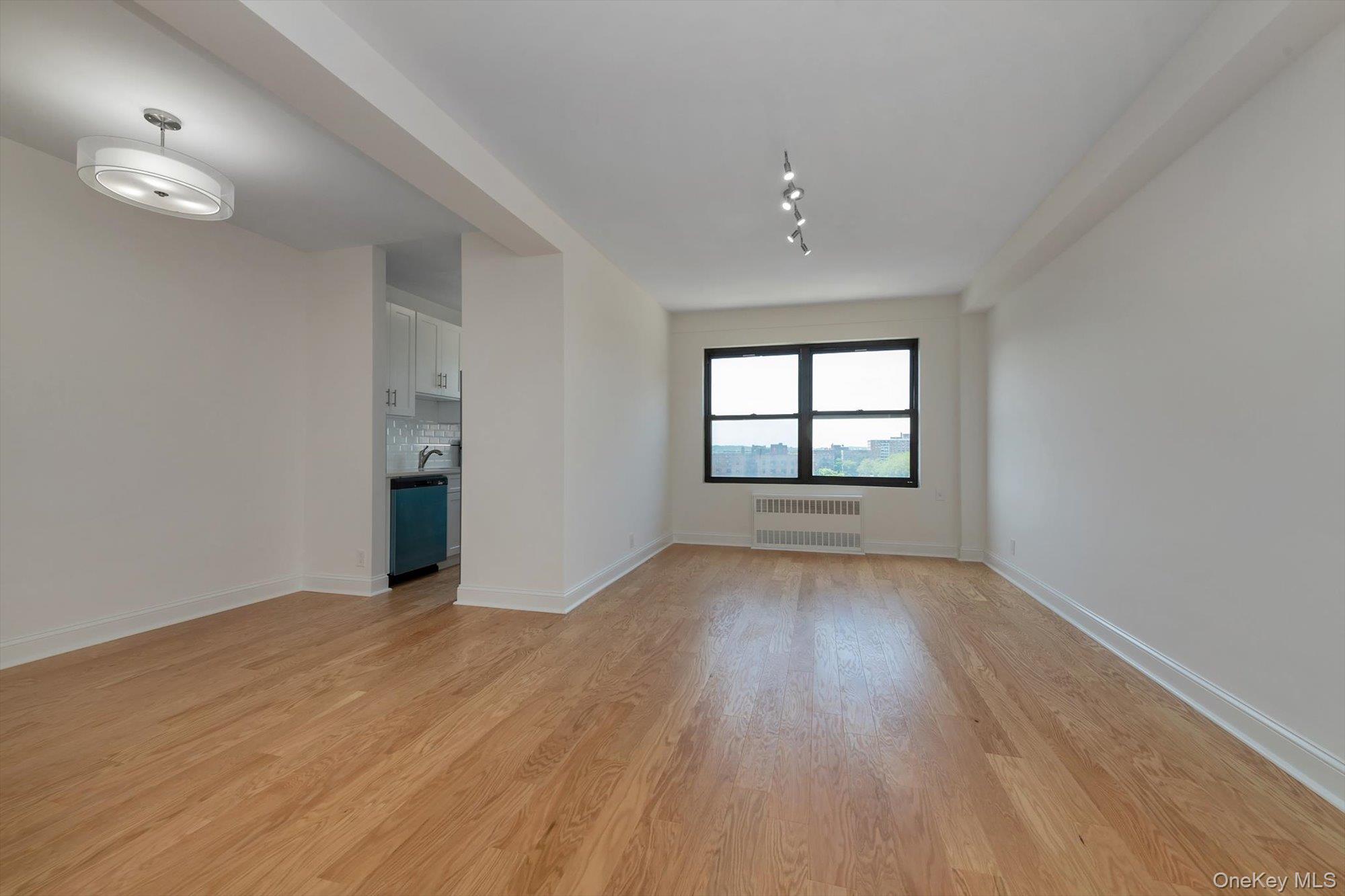 99-52 66th Road, Unit W7 Queens, NY 11374 - Photo 5 of 22 wooden floor in an empty room with a window