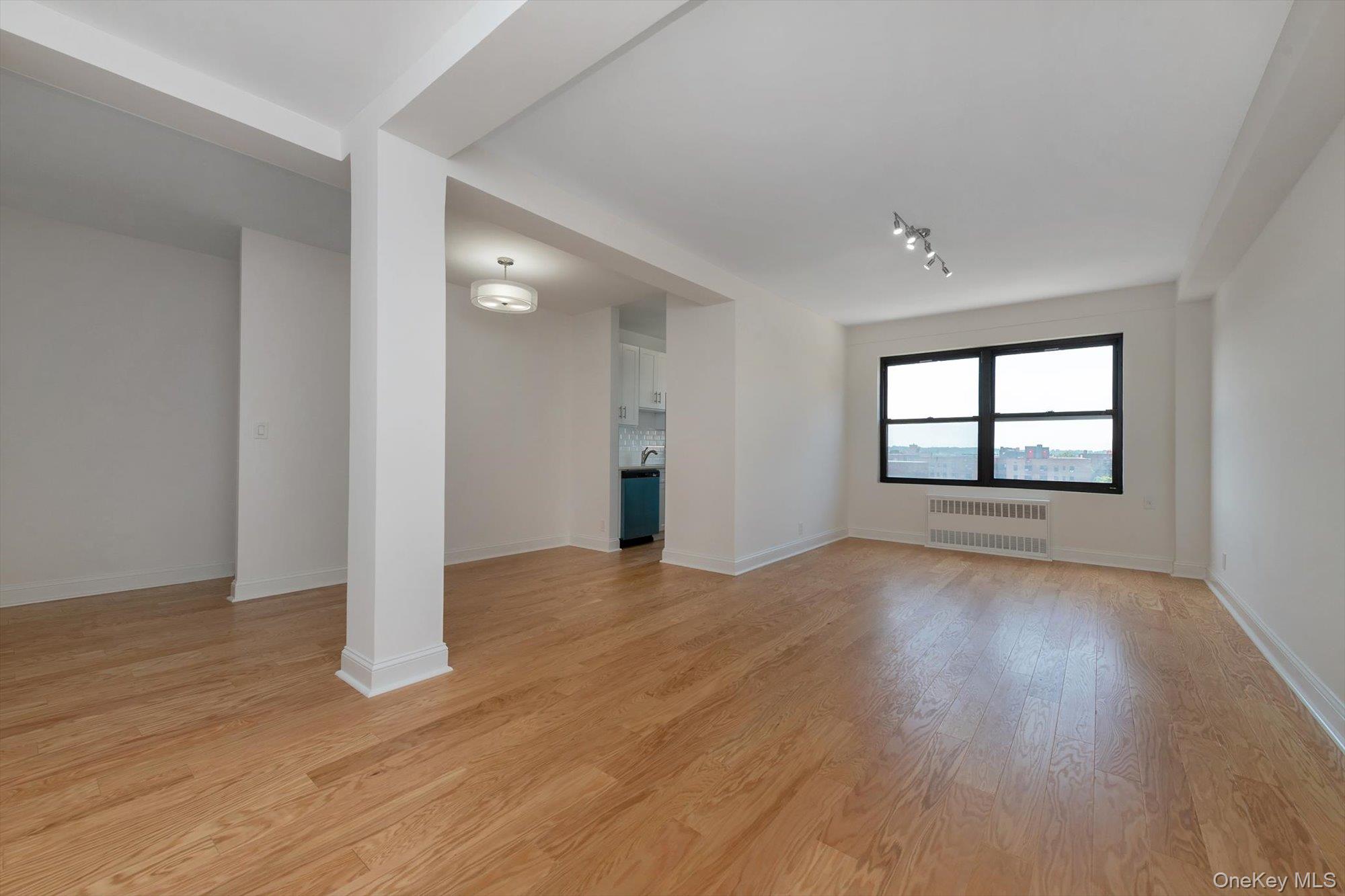 99-52 66th Road, Unit W7 Queens, NY 11374 - Photo 8 of 22 wooden floor in an empty room with a window