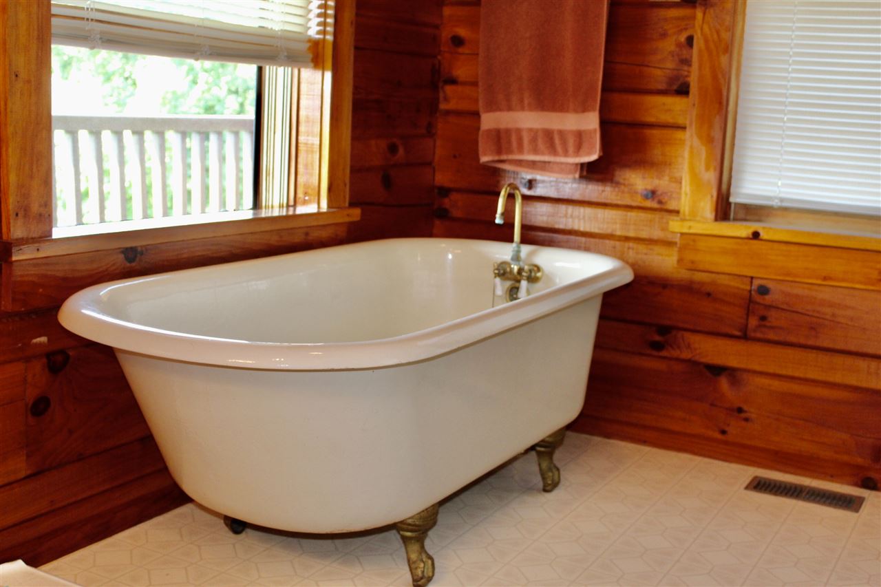1185 Bunker Hill Road Mount Solon, VA 22843 - Photo 19 of 39 a white bath tub sitting in a bathroom next to a window