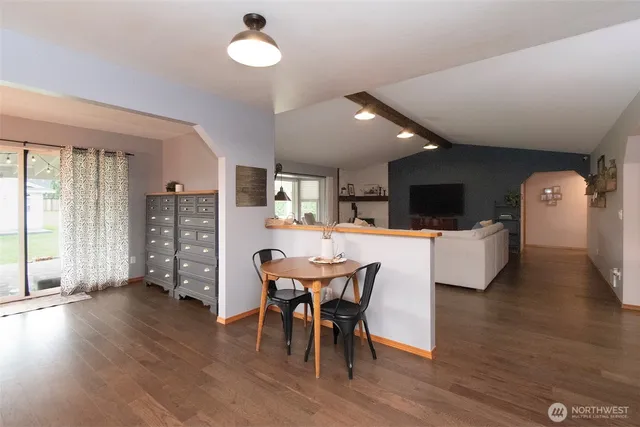 a view of a dining room with furniture and wooden floor