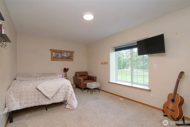 a spacious bedroom with a bed and a window