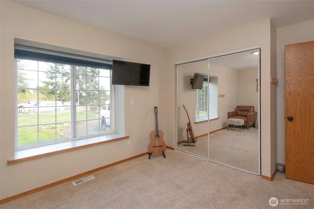 a view of a room with gym equipment and a large window