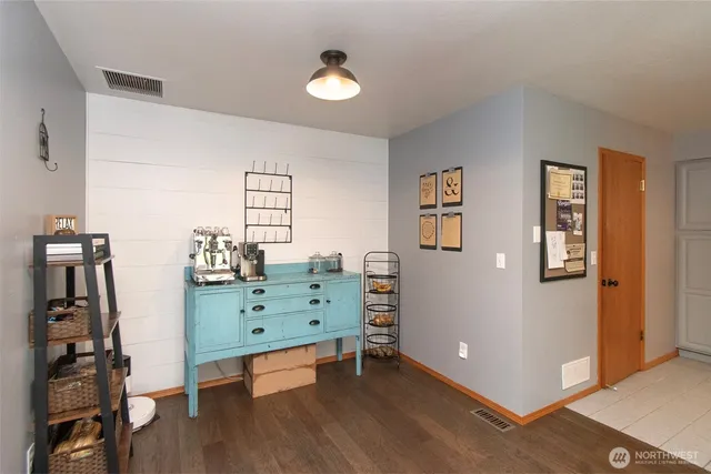 a view of a workspace with furniture and wooden floor