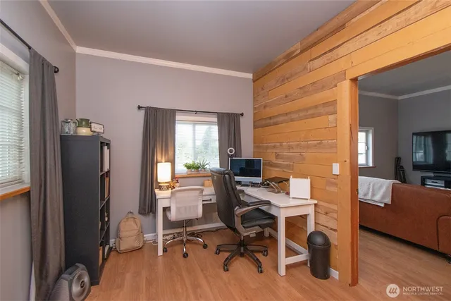 a view of a workspace with furniture and a window
