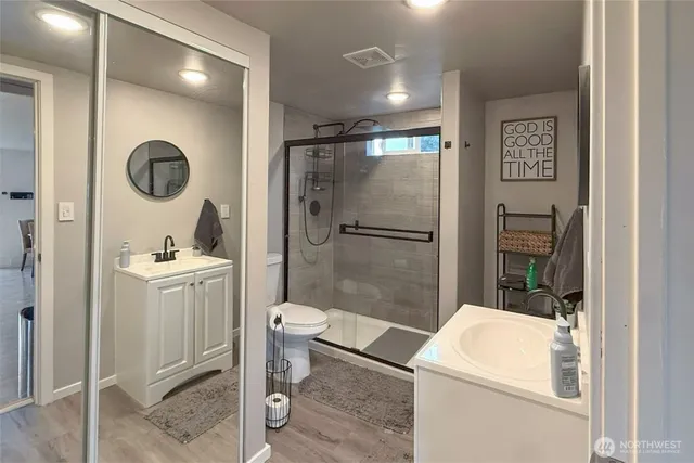a bathroom with a sink a toilet and shower