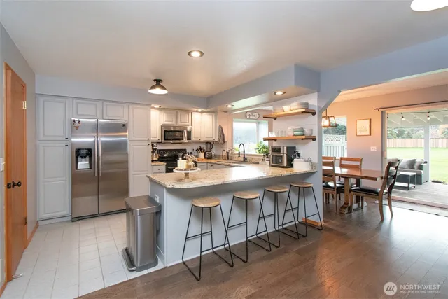 a kitchen with lots of counter top space and stainless steel appliances