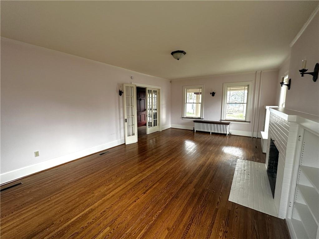919 Oak Street Indiana, PA 15701 - Photo 6 of 27 wooden floor in an empty room with a fireplace