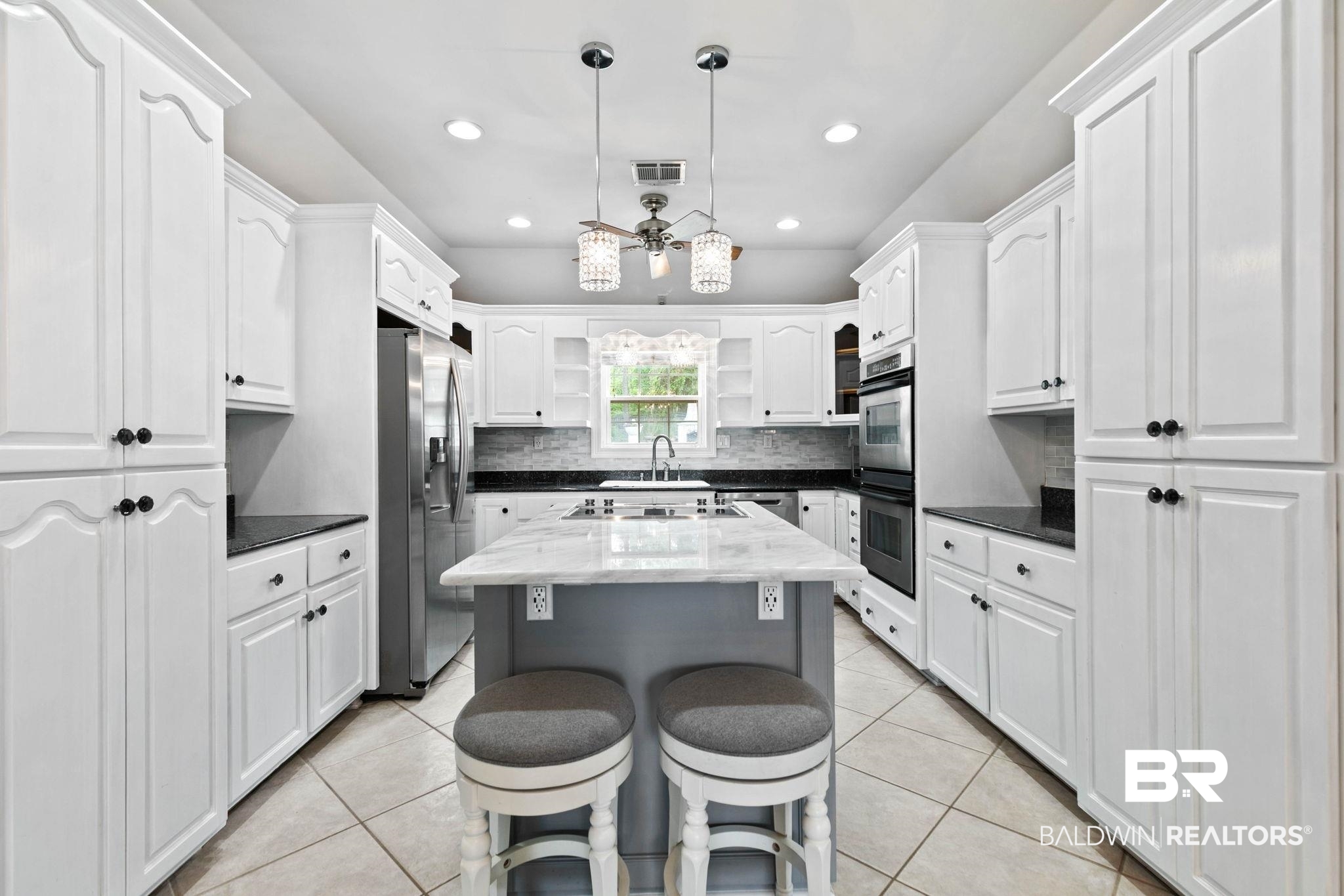 2 Speckle Trout Route Daphne, AL 36527 - Photo 15 of 61 Kitchen with open shelves, tasteful backsplash, dark stone counters, a center island, and white cabinetry
