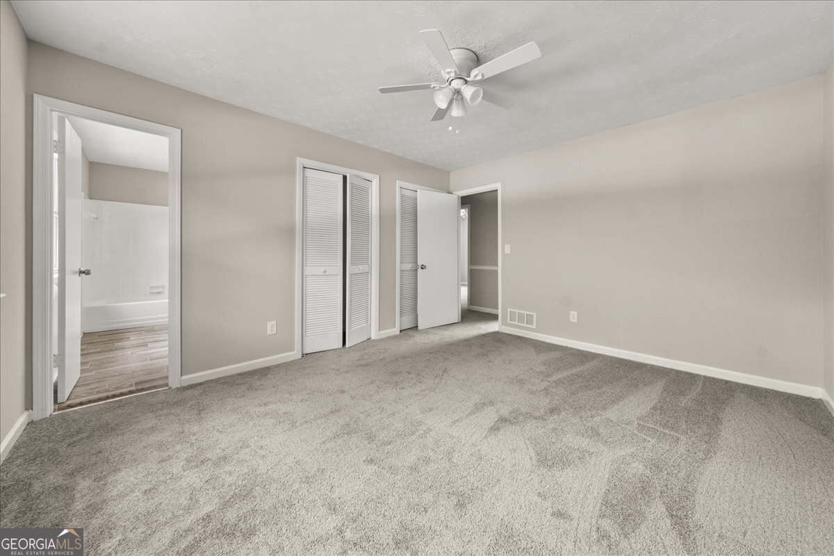 5058 Rock Springs Road Lithonia, GA 30038 - Photo 11 of 28 a view of an empty room with a fan