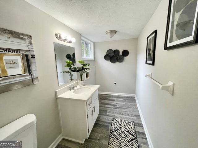 5058 Rock Springs Road Lithonia, GA 30038 - Photo 15 of 28 a bathroom with a sink toilet and mirror