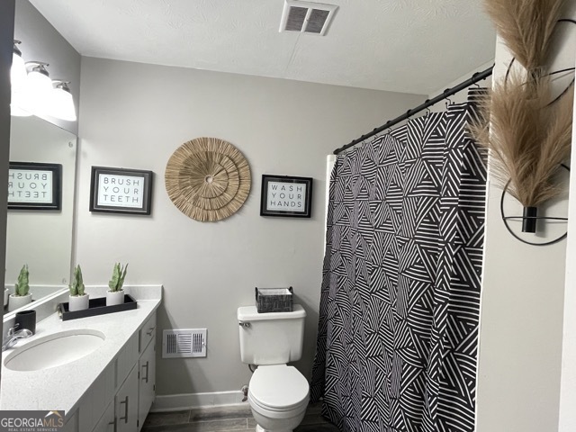5058 Rock Springs Road Lithonia, GA 30038 - Photo 16 of 28 a bathroom with a sink toilet and a mirror