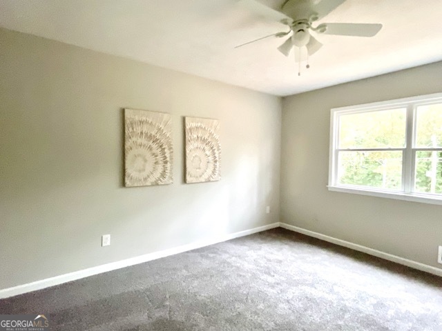 5058 Rock Springs Road Lithonia, GA 30038 - Photo 17 of 28 an empty room with windows and fan