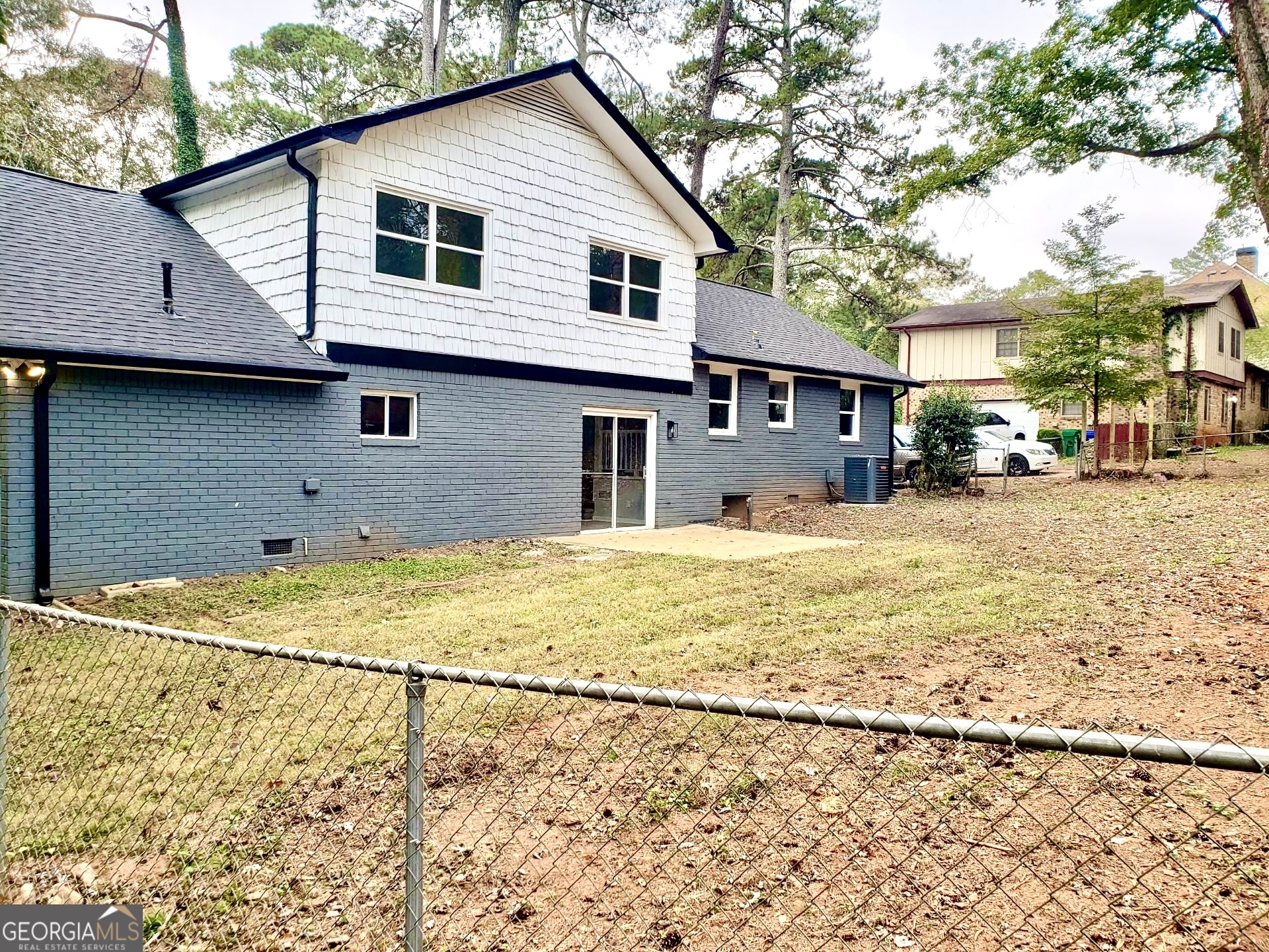 5058 Rock Springs Road Lithonia, GA 30038 - Photo 20 of 28 a front view of a house with a yard