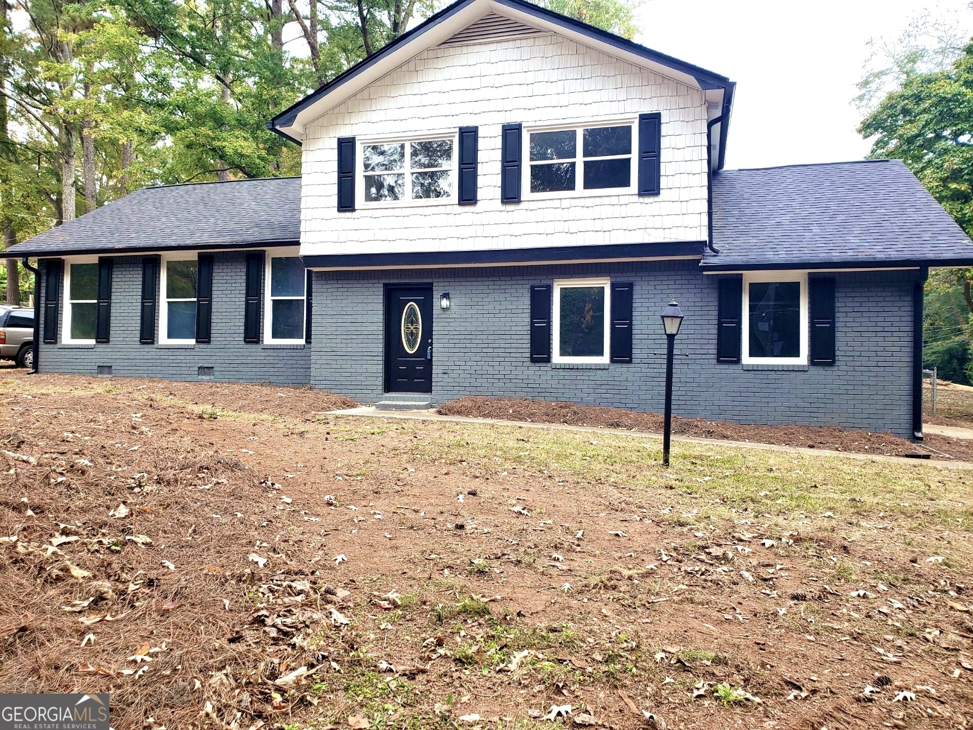 5058 Rock Springs Road Lithonia, GA 30038 - Photo 21 of 28 a front view of a house with a yard