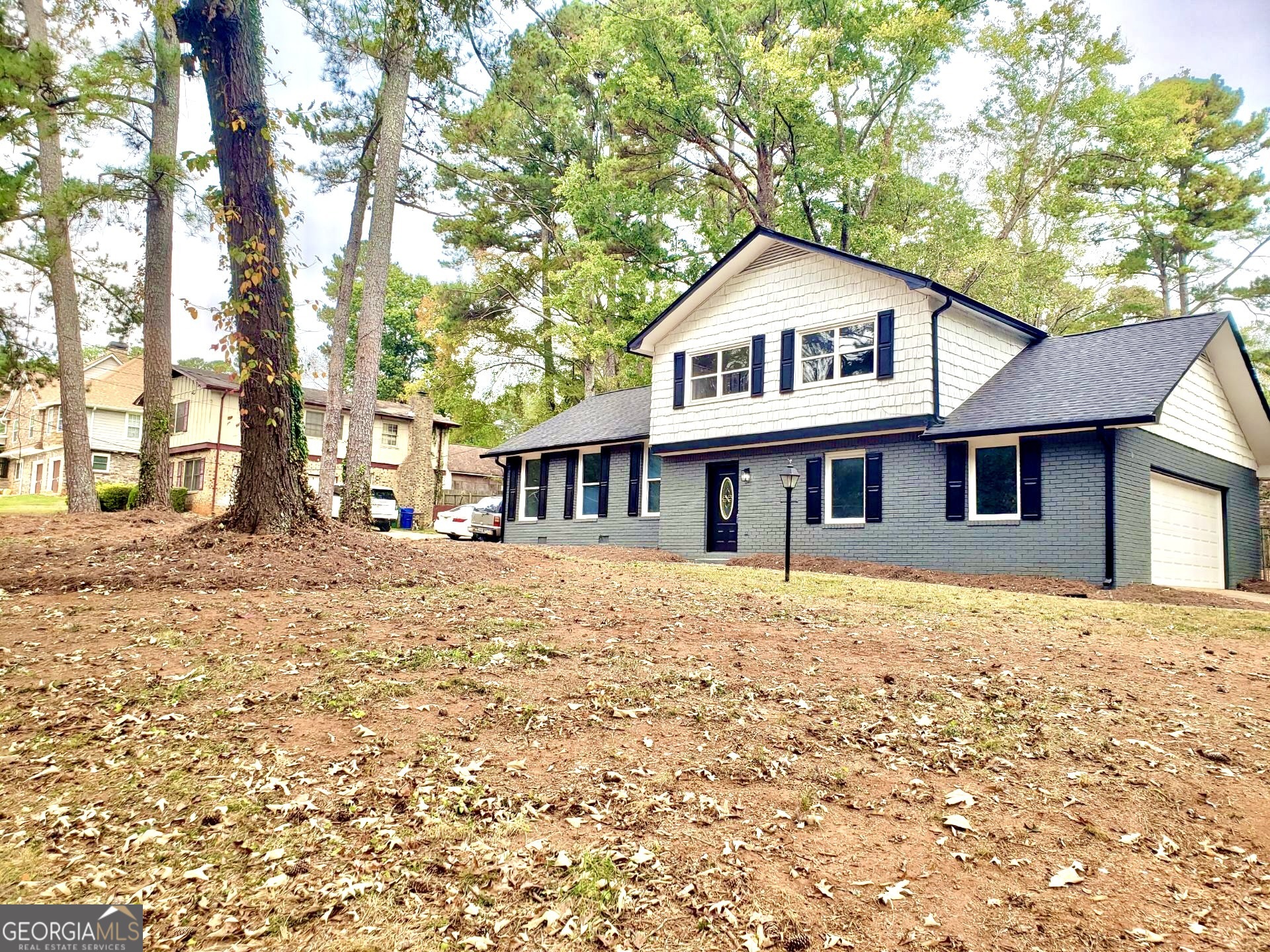 5058 Rock Springs Road Lithonia, GA 30038 - Photo 22 of 28 a front view of a house with a yard