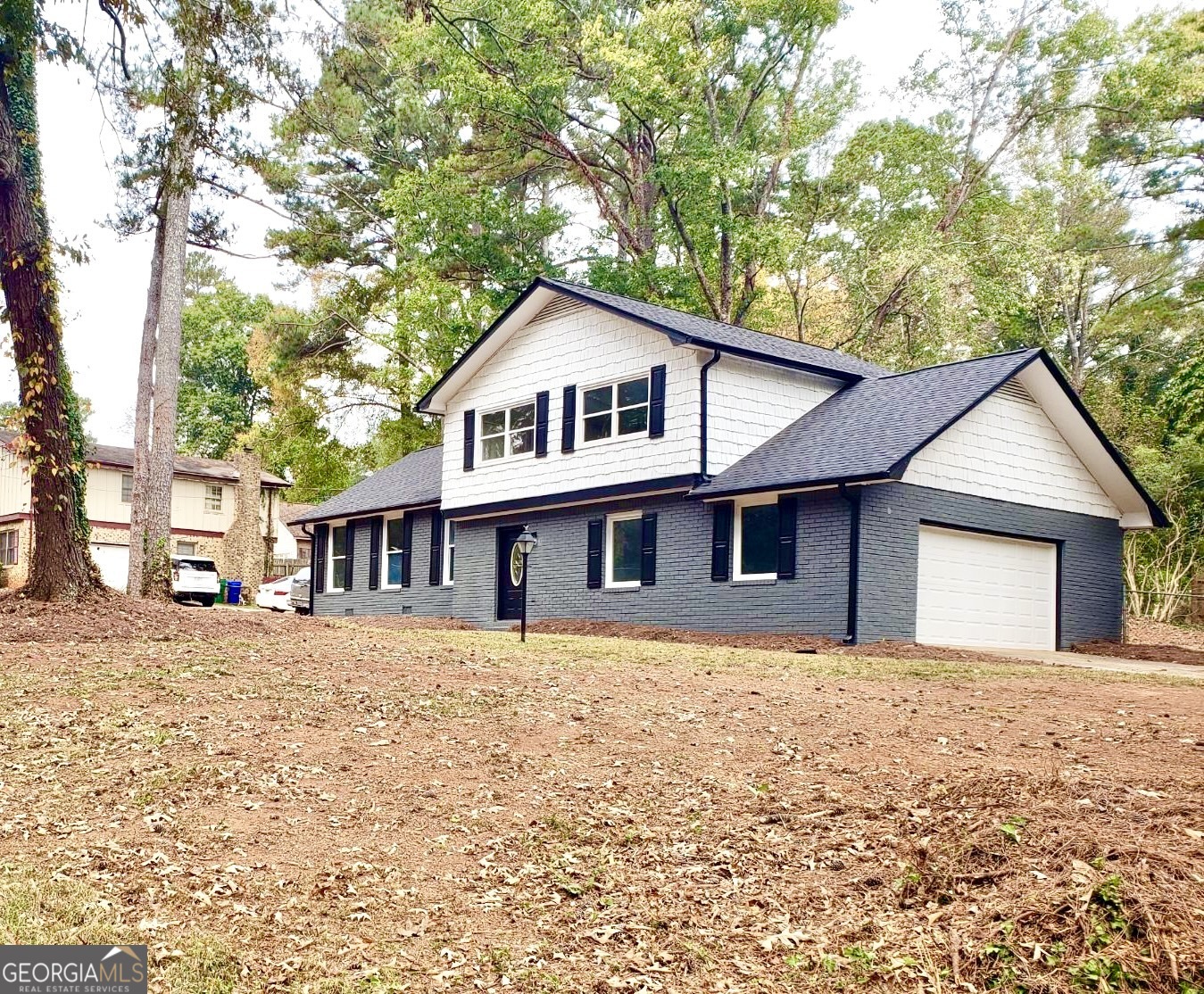 5058 Rock Springs Road Lithonia, GA 30038 - Photo 23 of 28 a front view of a house with a garden and trees
