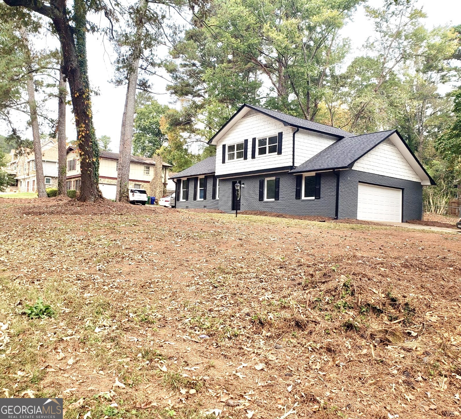 5058 Rock Springs Road Lithonia, GA 30038 - Photo 24 of 28 a front view of a house with a garden and trees
