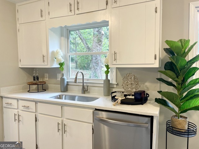5058 Rock Springs Road Lithonia, GA 30038 - Photo 6 of 28 a kitchen with a sink a window and cabinets