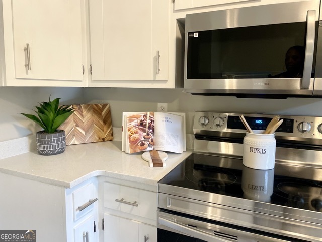 5058 Rock Springs Road Lithonia, GA 30038 - Photo 7 of 28 a kitchen with a microwave and cabinets