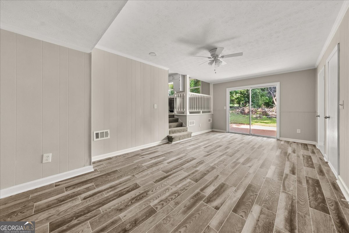 5058 Rock Springs Road Lithonia, GA 30038 - Photo 9 of 28 a view of empty room with wooden floor and fan
